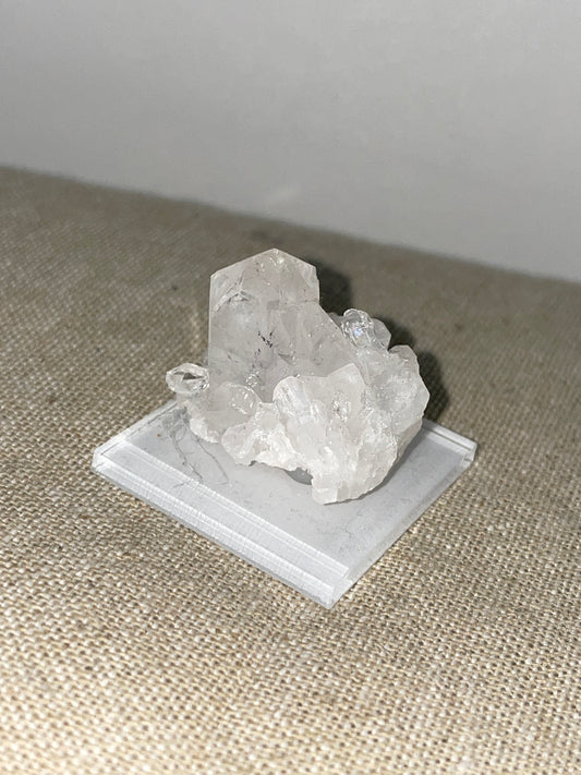 Clear quartz point cluster mounted